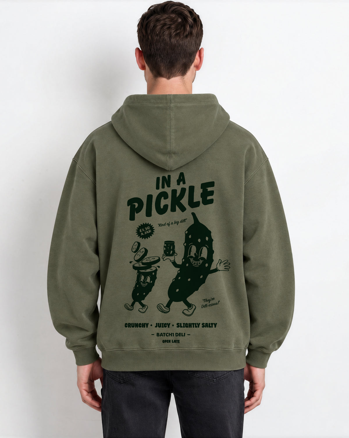 Male model wearing the In a Pickle olive oversized hoodie, back print view