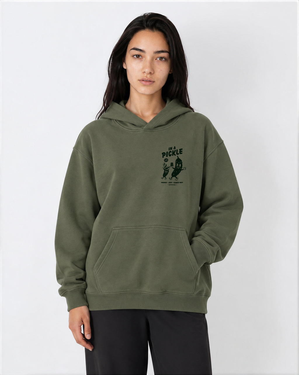 Female model wearing the In a Pickle olive oversized hoodie, front view