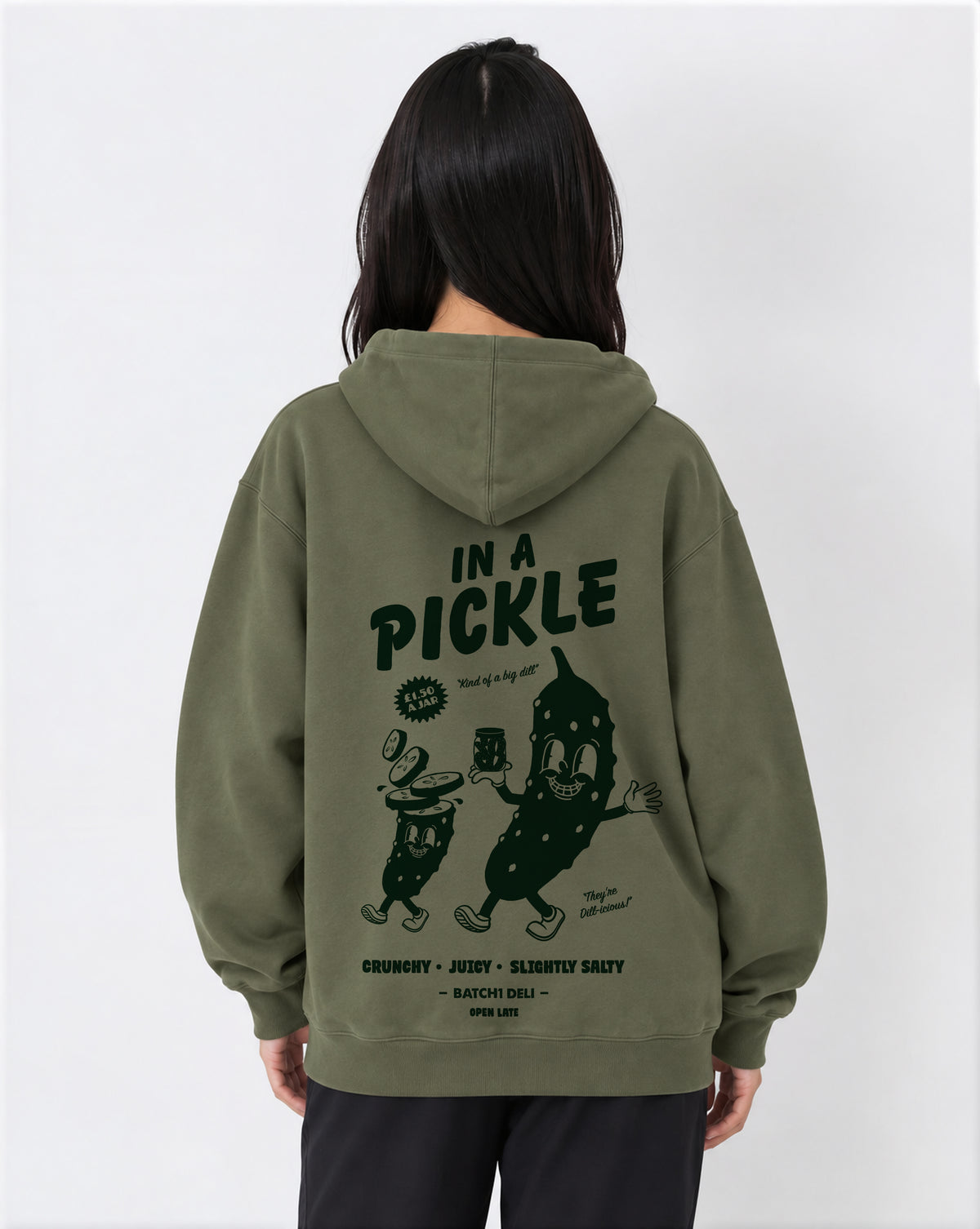 Female model wearing the In a Pickle olive oversized hoodie, back print view