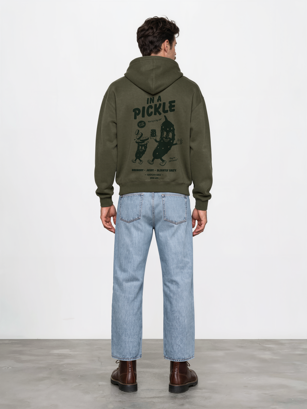 Male model wearing the Batch1 In a Pickle oversized olive hoodie, back view with dark green large pickle graphic.