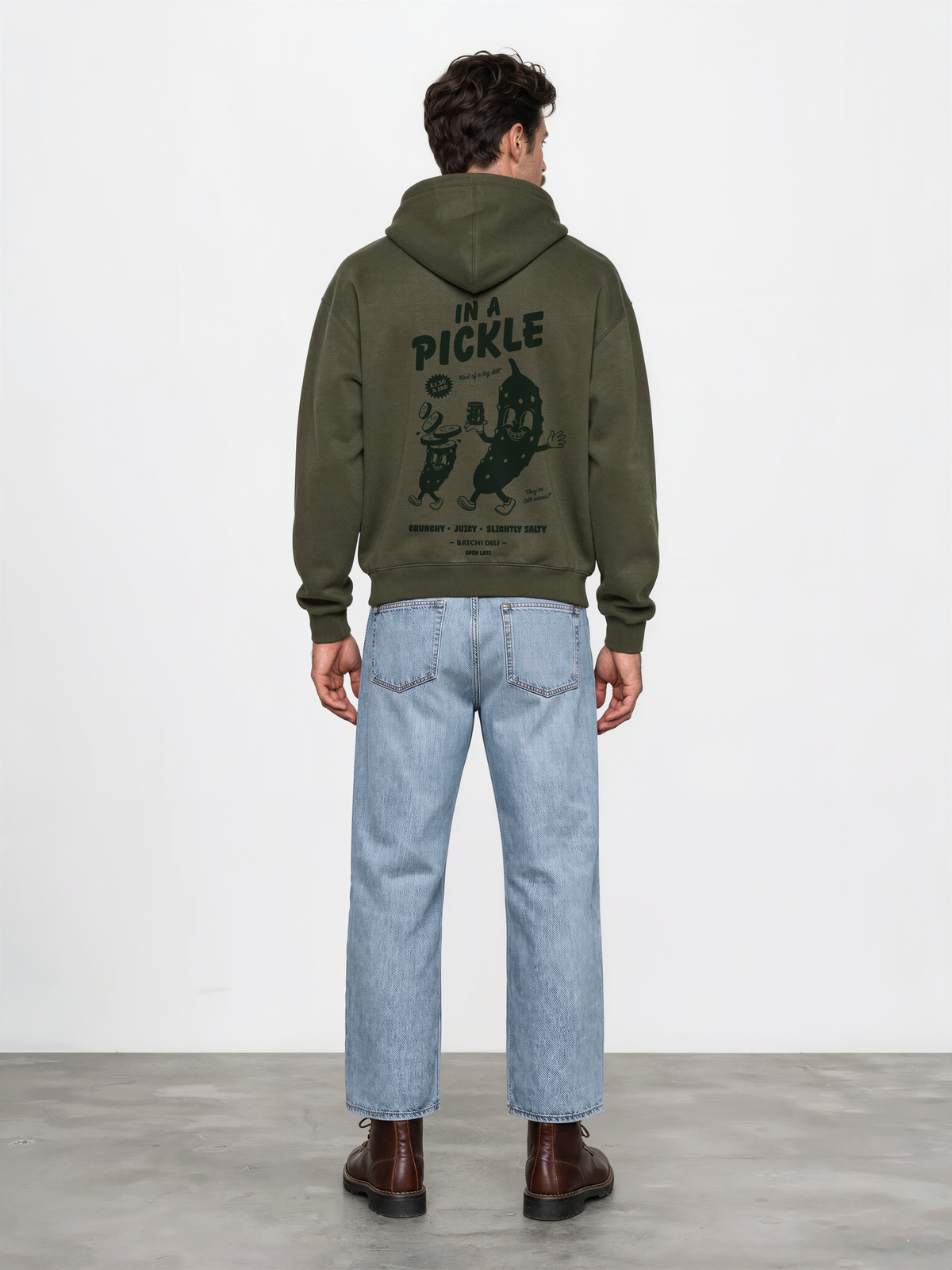 Male model wearing the Batch1 In a Pickle oversized olive hoodie, back view with dark green large pickle graphic.