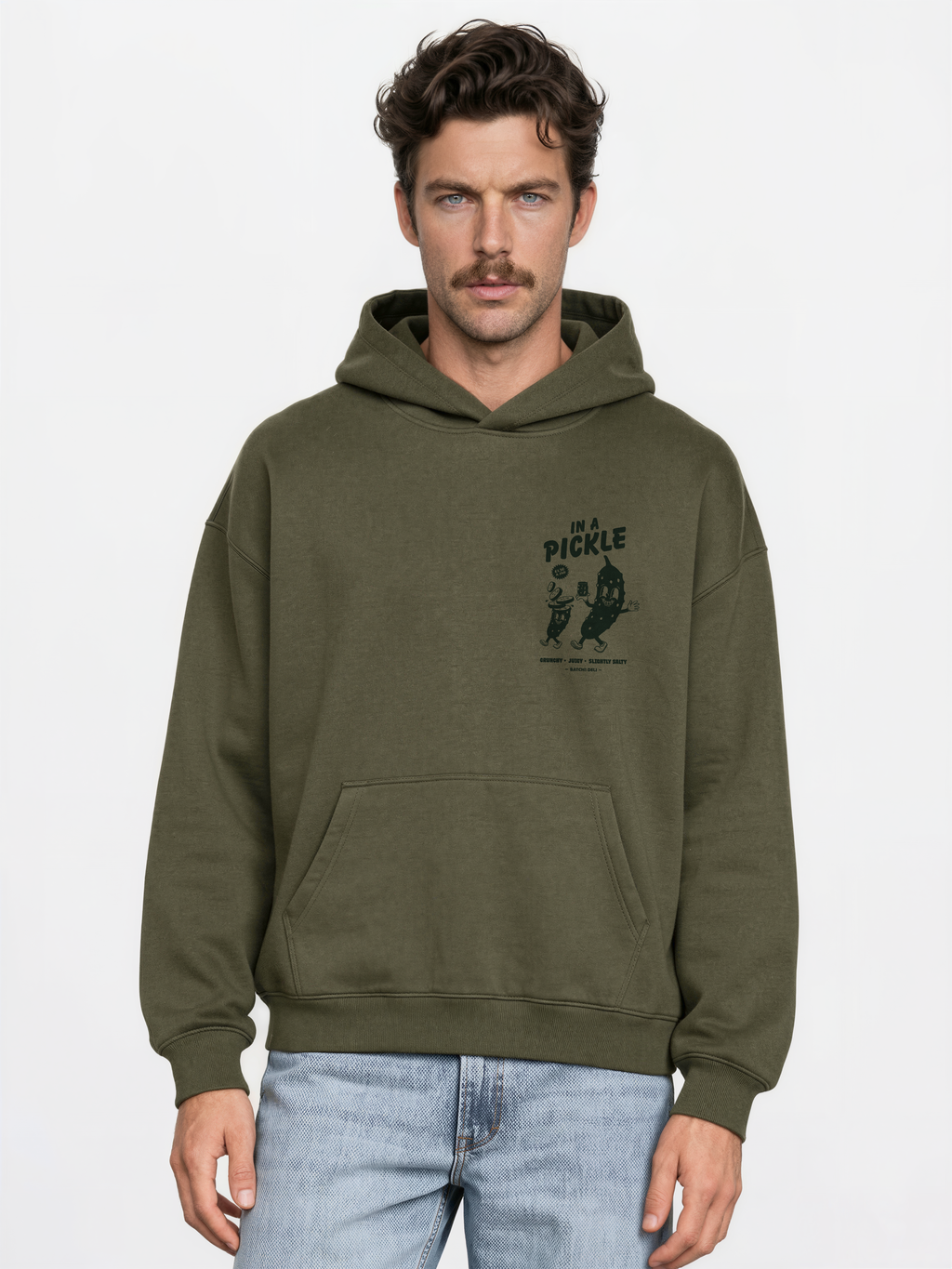 Male model wearing the Batch1 In a Pickle oversized olive hoodie, front view with dark green left-chest print.