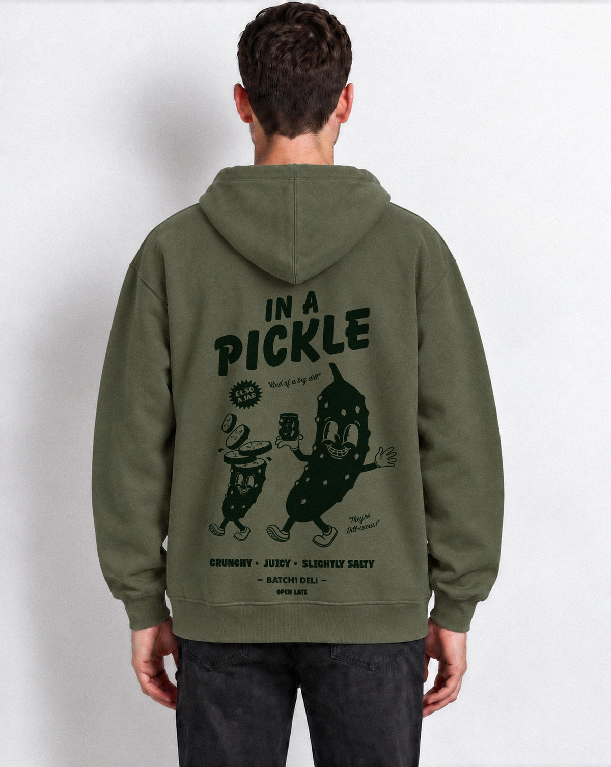 Male model wearing the Batch1 In a Pickle oversized Olive hoodie, back view with large dark green pickle graphic.