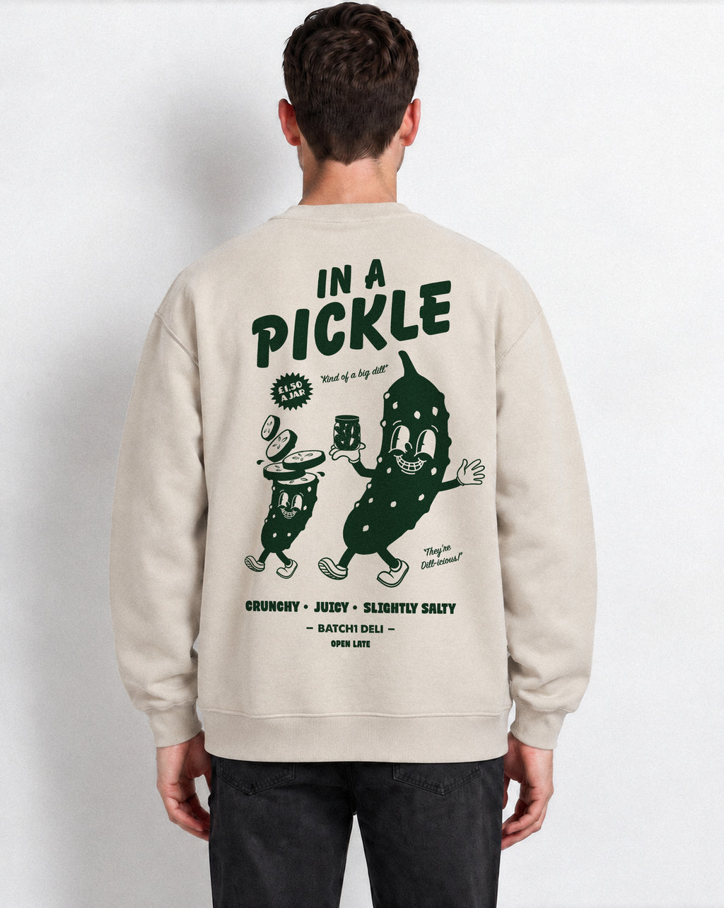 Male model wearing the In a Pickle oversized sweatshirt in Stone, back view with large back dark green graphic