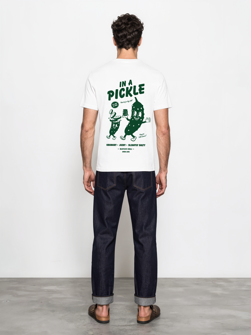 Male model wearing the Batch1 In a Pickle white T-shirt, back view with large dark green pickle graphic.