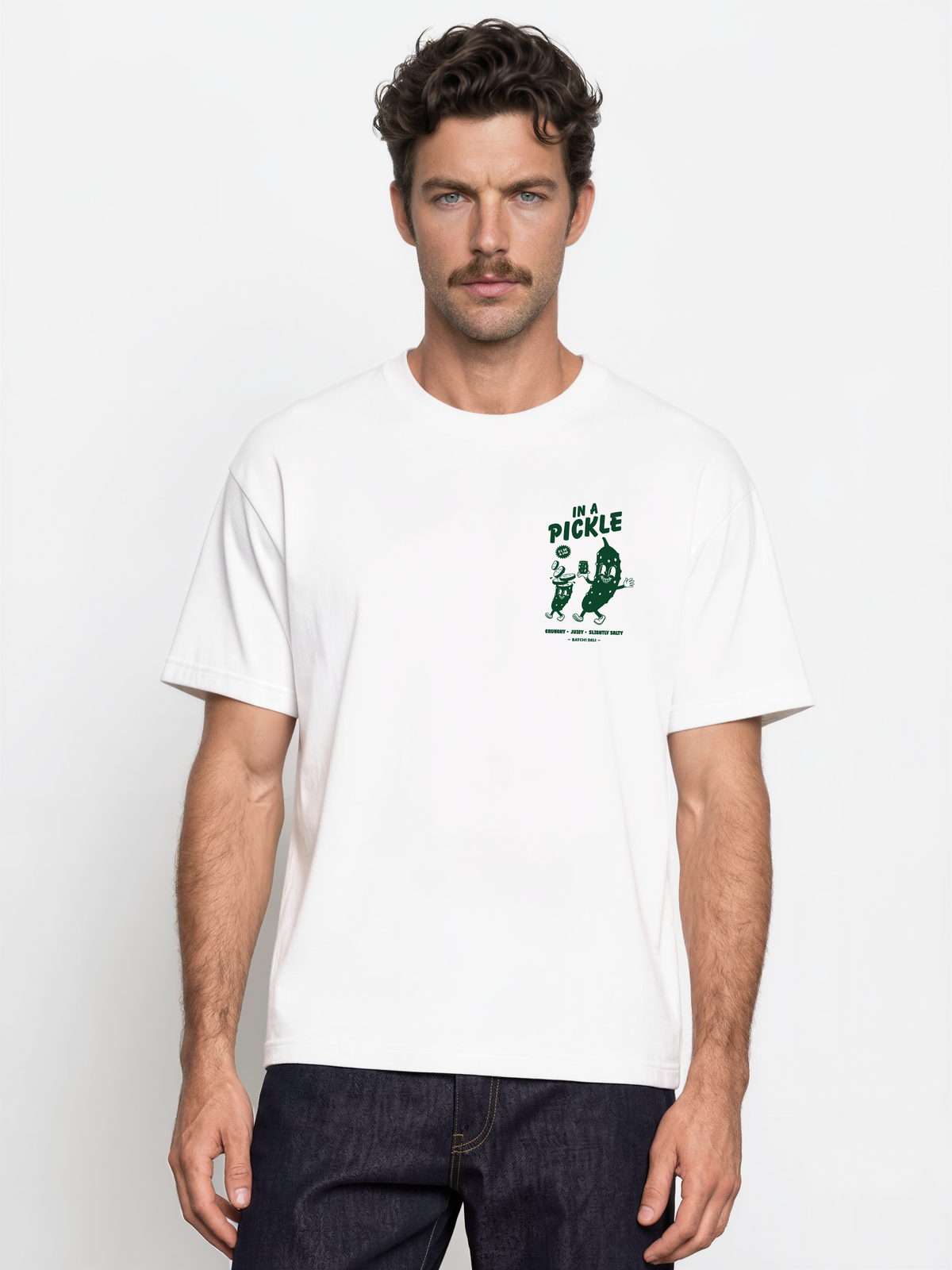 Male model wearing the Batch1 In a Pickle white T-shirt, front view with dark green left-chest print.