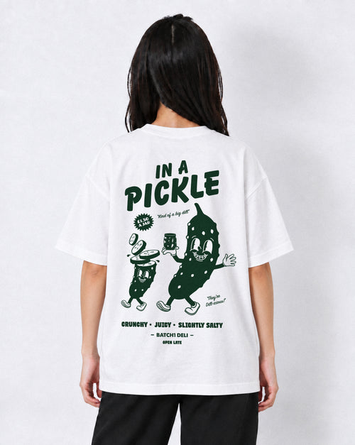 Female model wearing the Batch1 In a Pickle white T-shirt, back view with large dark green pickle graphic.