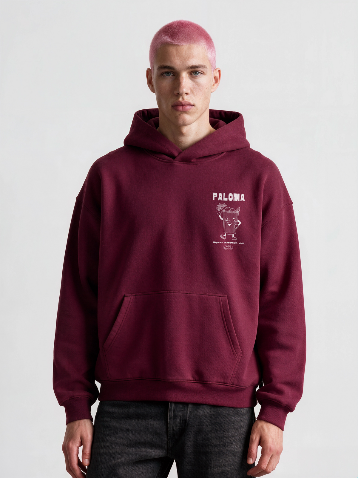 Male model wearing the Paloma burgundy oversized hoodie, front view showing the white left-chest print.