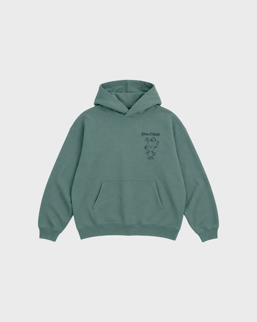Front flat lay of the Piña Colada pine oversized hoodie, showing the small teal Piña Colada cocktail print on the left chest.