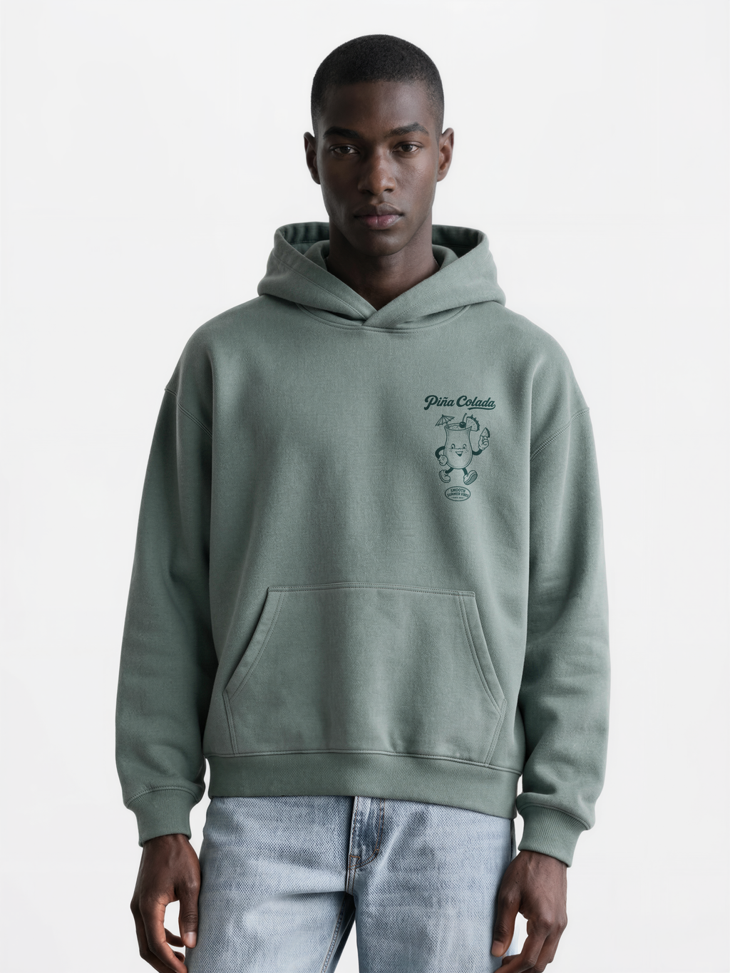 Male model wearing the Piña Colada pine oversized hoodie, showing the small teal Piña Colada cocktail print on the left chest.