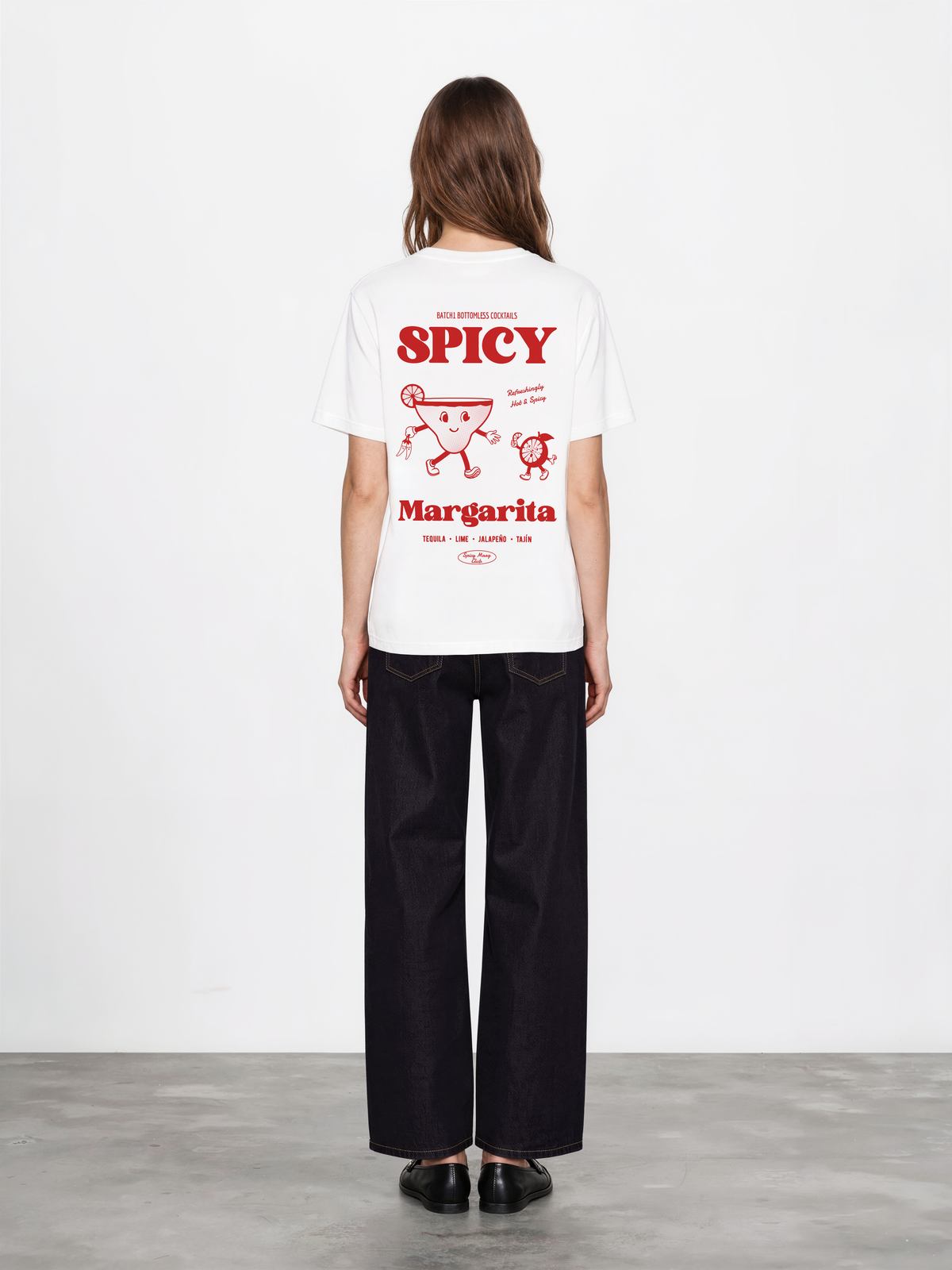 Female model wearing the Spicy Margarita white T-shirt, showing the red cocktail and lettering back print