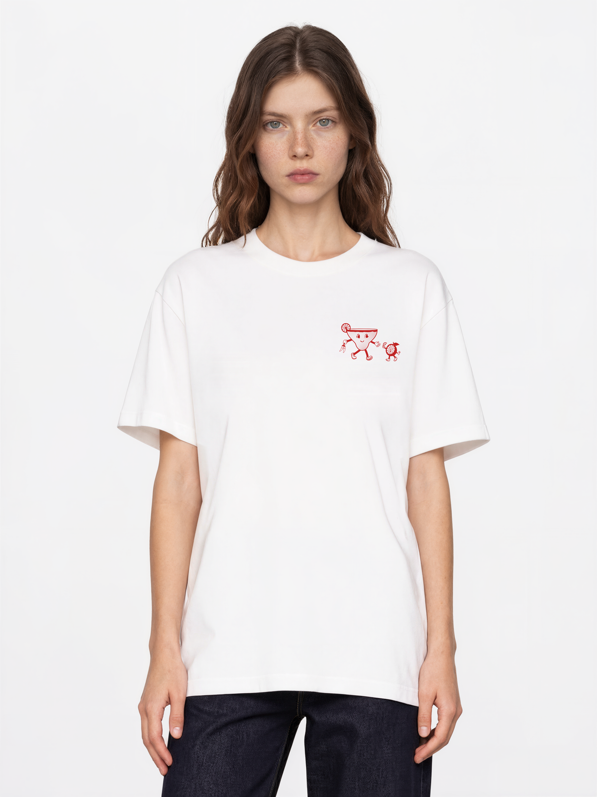 Female model wearing the Spicy Margarita white T-shirt, showing the small red left-chest cocktail print
