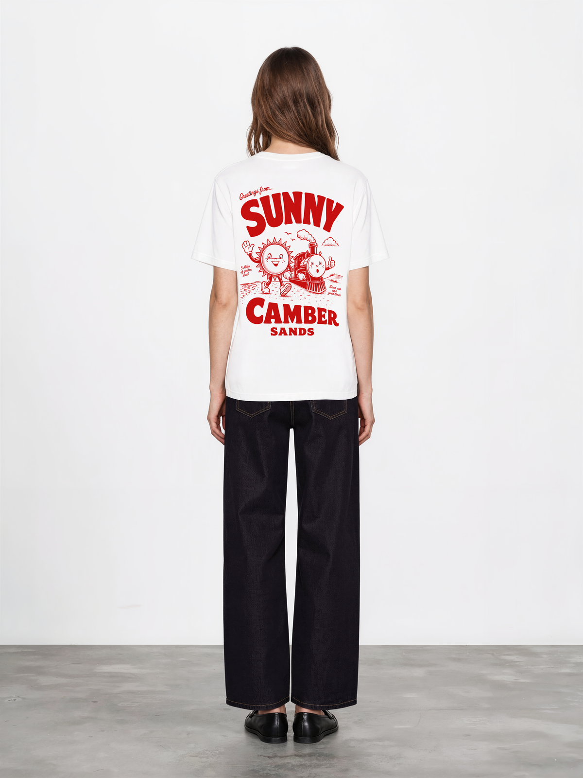 Sunny Camber Sands white T-shirt, back female model view, showing the larger red seaside sun and steam train back design
