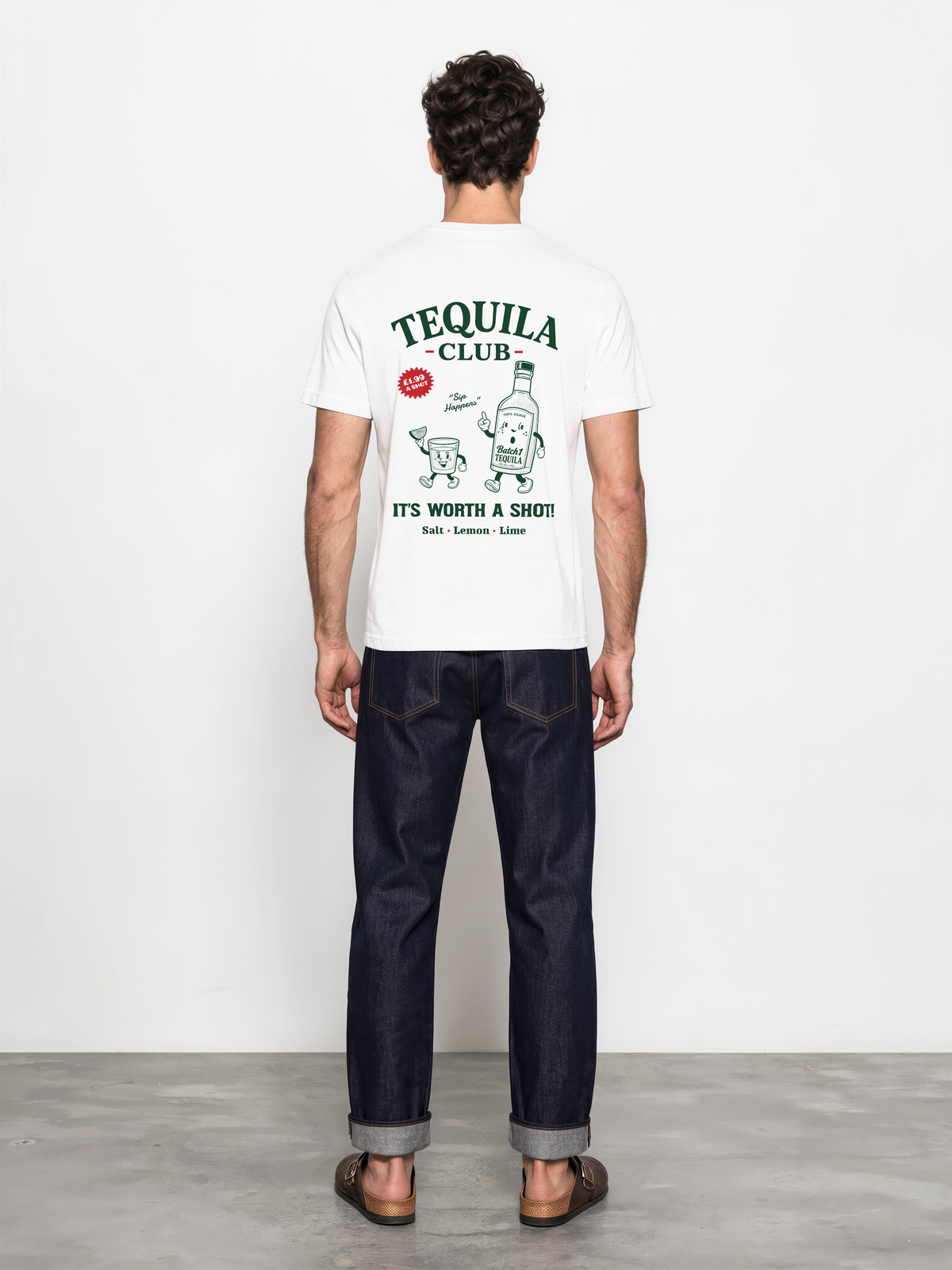 Male model wearing the white Tequila Club graphic T-shirt, back view showing green tequila bottle and shot-glass artwork with red accents.