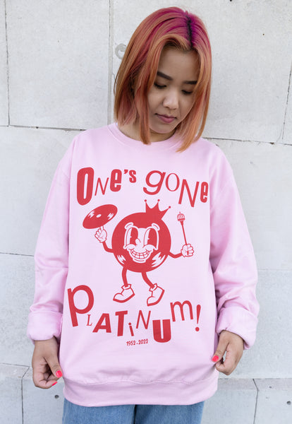 Model wears pink sweatshirt with "One's Gone Platinum"Jubilee slogan 