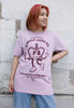 Model wears dusty purple unisex tshirt with 'Lovely Jubilee" slogan and crown character graphic 