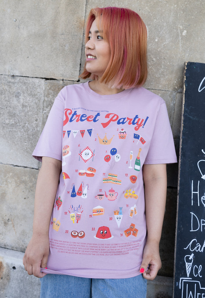 Model wears pink tshirt with Street Party guide graphic for Platinum Jubilee 