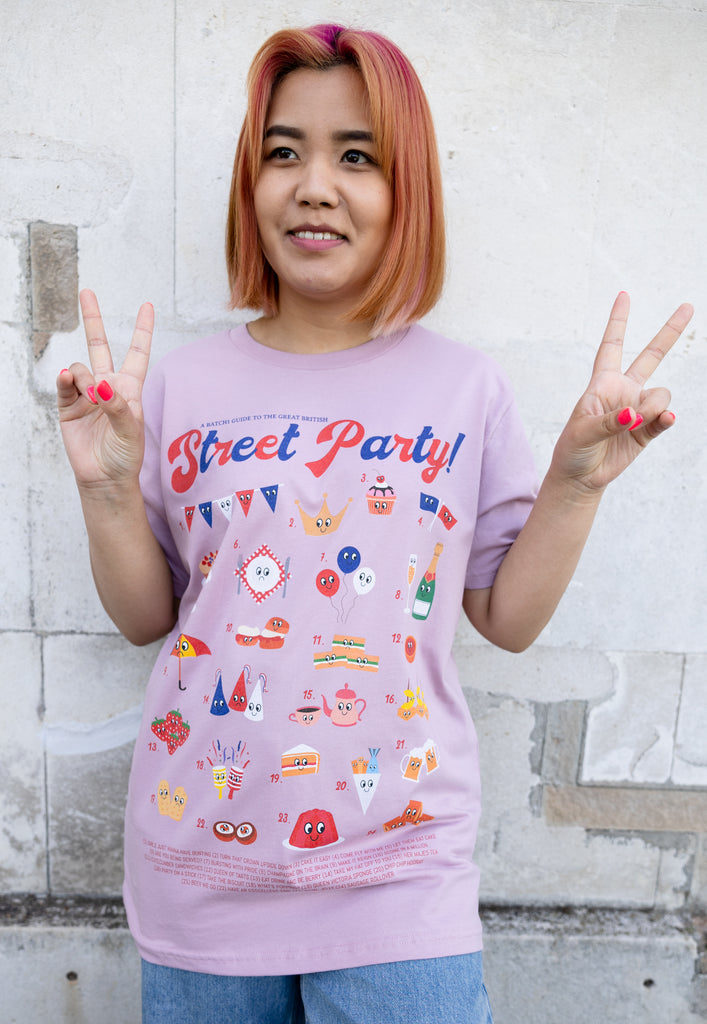 Model wears pink tshirt with Street Party Guide graphic for Platinum Jubilee 