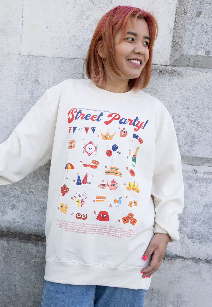 Model wears vanilla sweatshirt with Street Party Guide for Platinum Jubilee
