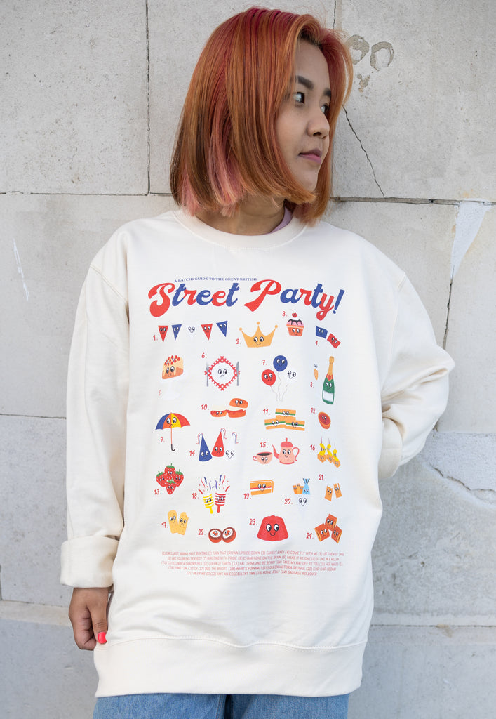 Model wears vanilla sweatshirt with Street Party Guide for Platinum Jubilee
