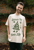 male model wears vintage style printed christmas t shirt with spruce up your life slogan and christmas tree graphic