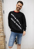 mens christmas jumper with college style lettering reading north pole skate patrol