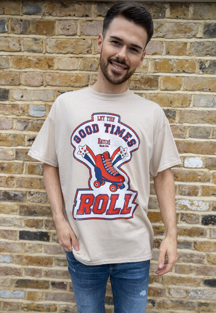 male model wears sand coloured cotton t shirt with bold printed retro roller skate graphic and let the good times roll slogan on front of t shirt