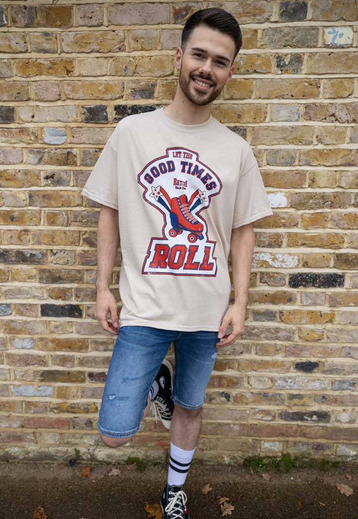 male model wears retro 70s roller skate t shirt in natural with bold graphic print on front and positive slogan