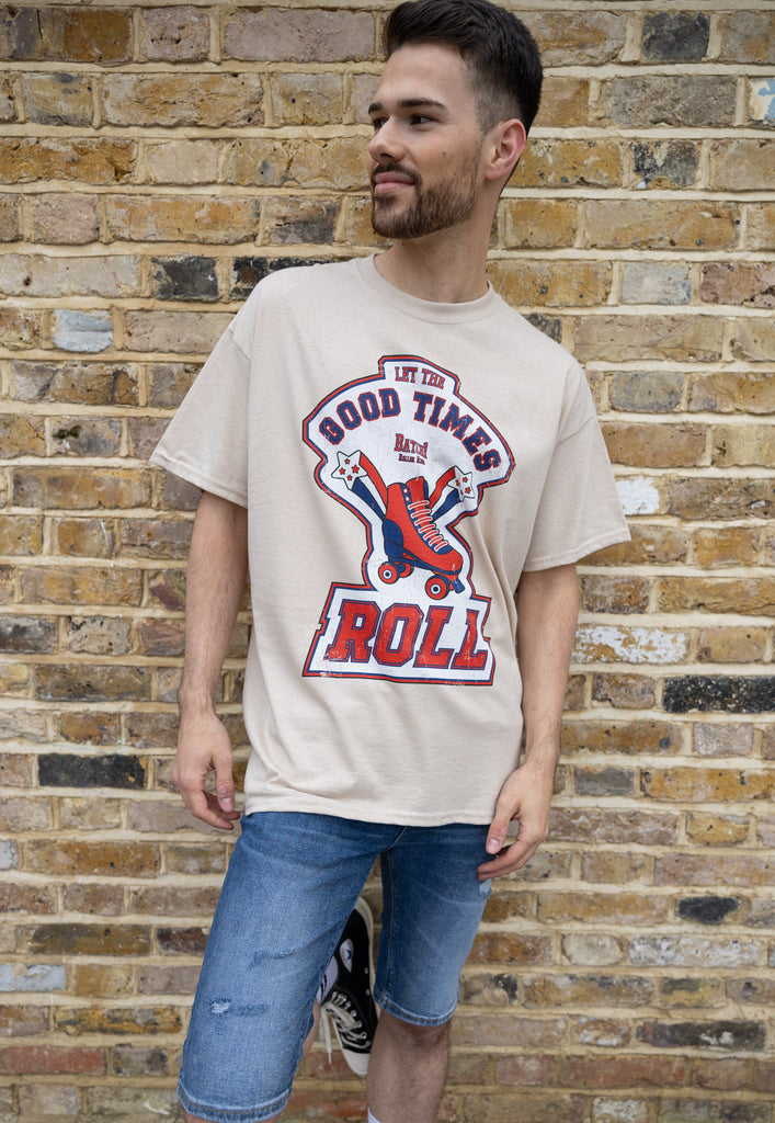 male model wears vintage style roller skate t shirt in sand colour with let the good times roll print