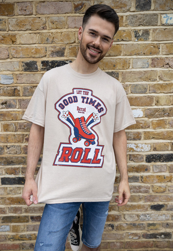 close up product shot of male model wearing relaxed fit vintage style roller skate t shirt in sand with good times slogan