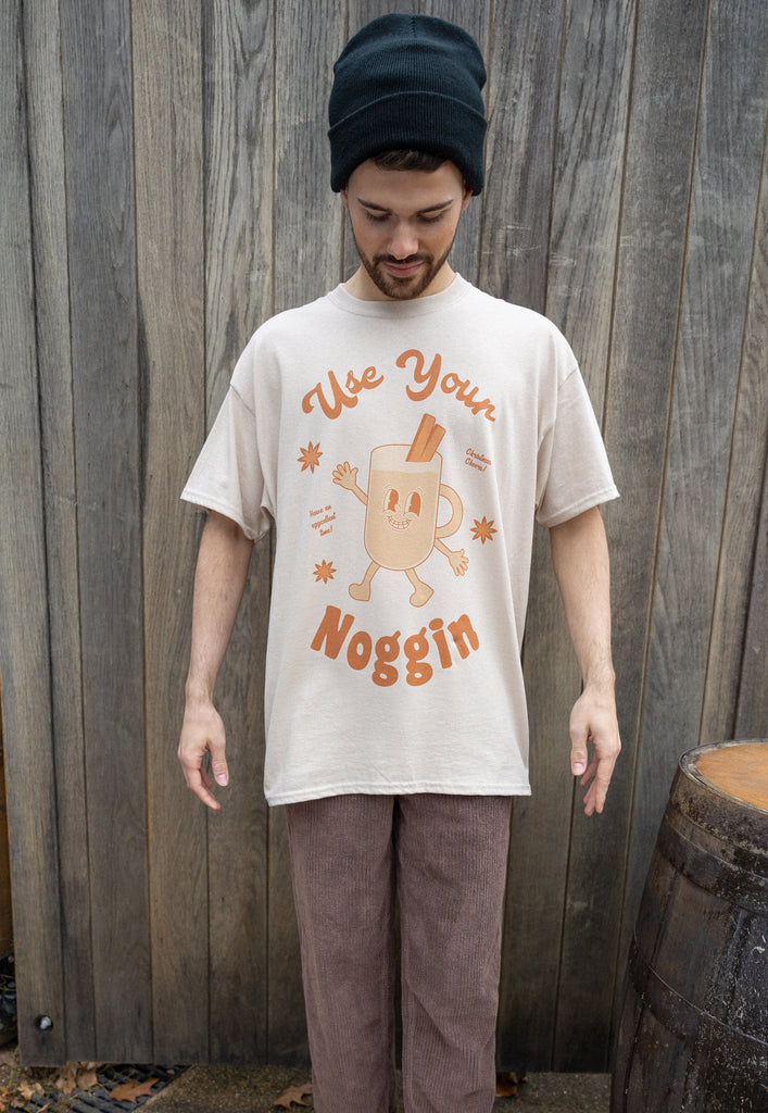 male model wears relaxed fit festive t shirt with egg nog theme and retro character print