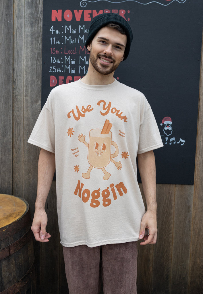 cosy image of male model wearing vintage style christmas cocktail t shirt featuring egg nog character and slogan 