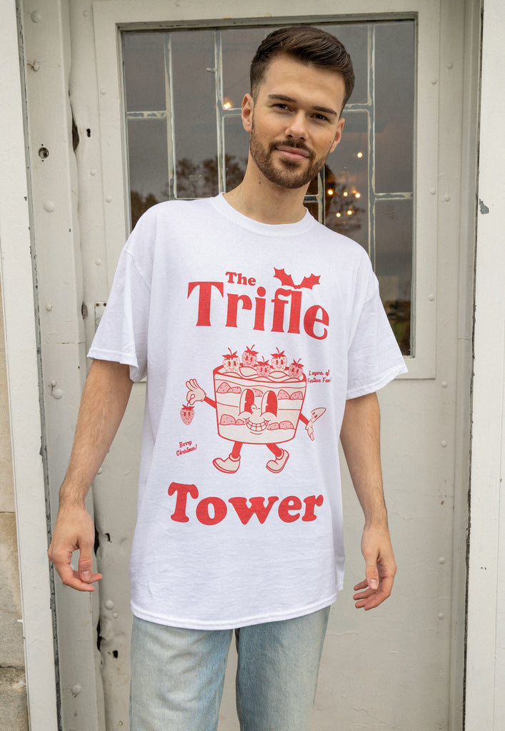 male model is wearing christmas t shirt in white with red print showing 'trifle tower' slogan and fun character 