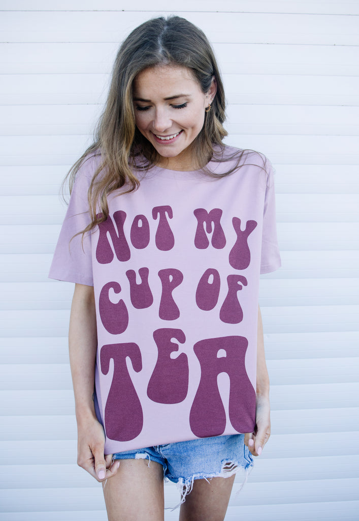 Model wears dusty purple tshirt with not My Cup of Tea slogan 