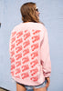 female model is wearing casual pink sweatshirt with repeat pattern cherry logo back print 