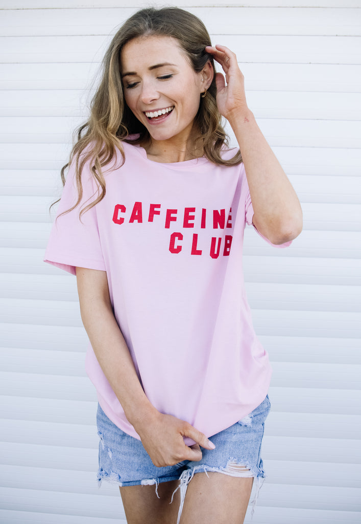 Model wears caffeine club logo tshirt in pastel pink 