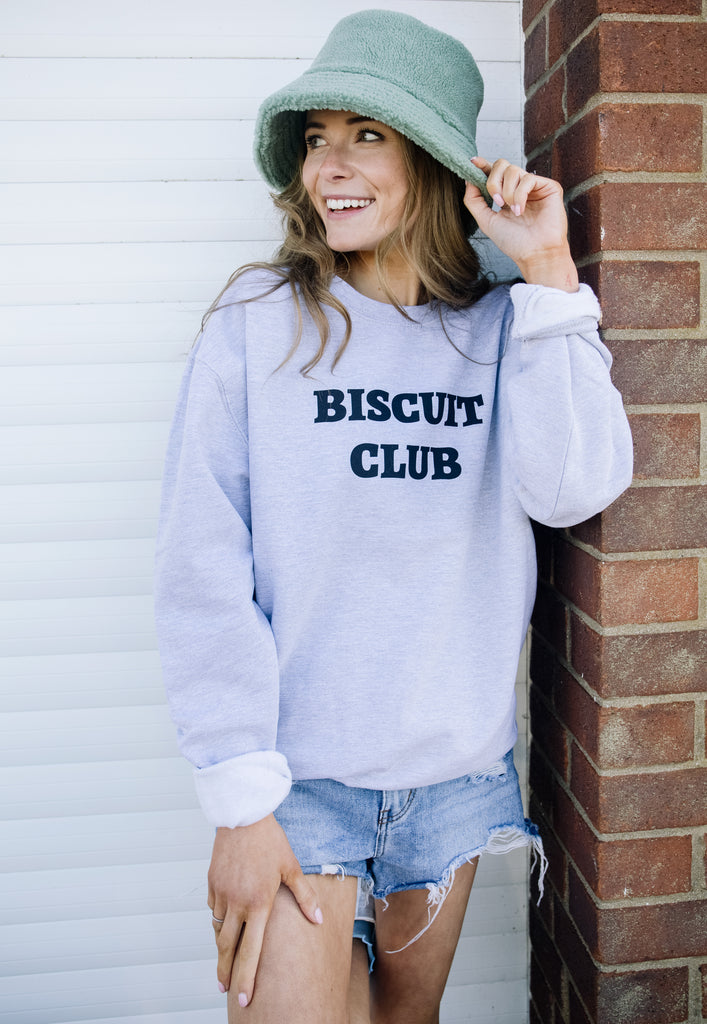Model wears biscuit slogan sweater