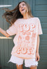 Model wears dusty peach tshirt with Top of the Pots slogan and 70s style plant pot character graphic 