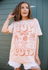 Model wears dusty peach tshirt with Top of the Pots slogan and 70s style plant pot character graphic 