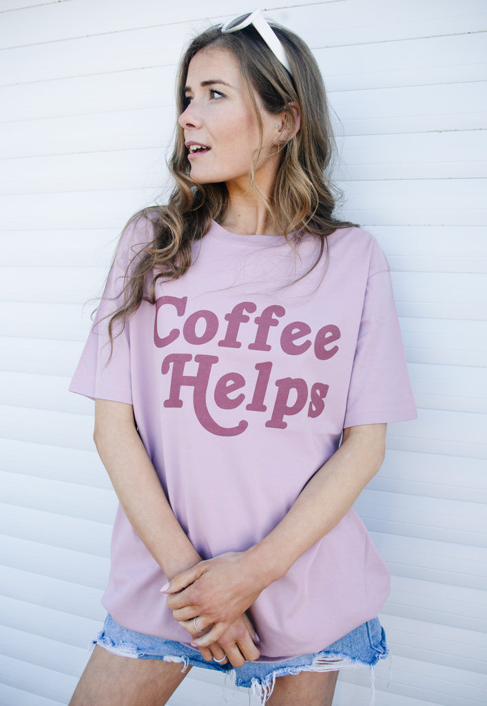 Model wears coffee slogan t-shirt