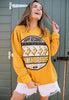 Model wears yellow sweatshirt with printed record graphic and dancing bananas