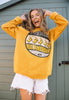 model wears yellow sweater printed with all the peels slogan music graphics and banana characters