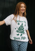 female model wears positive christmas slogan t-shirt in vintage style with christmas tree print