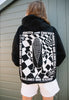 model is wearing unisex black hooded sweatshirt with large rave flyer graphic back print in white
