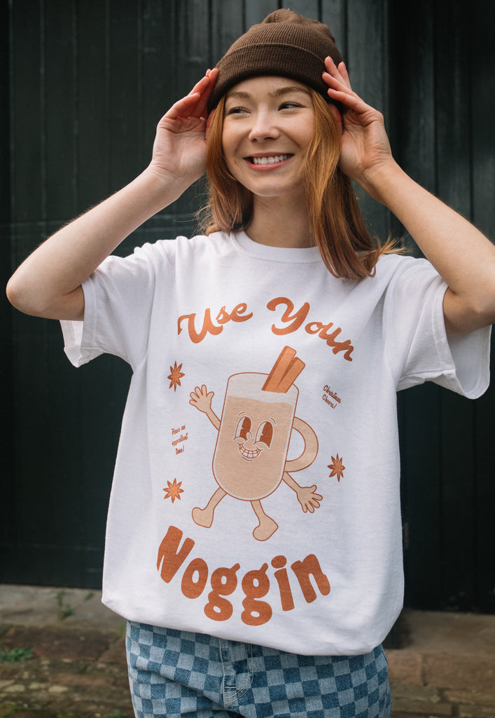 female model is wearing christmas egg nog t-shirt with cute vintage style character graphic