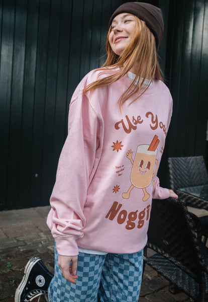 cute christmas jumper in pink with egg nog character