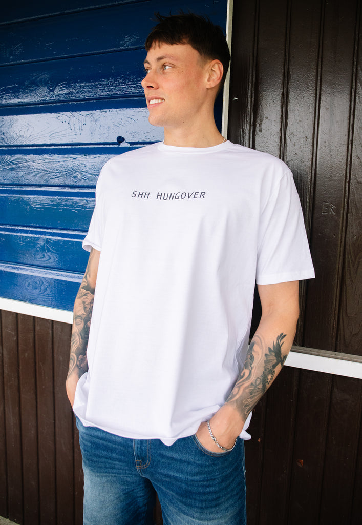 model wears white tshirt with Shh Hungover printed slogan 