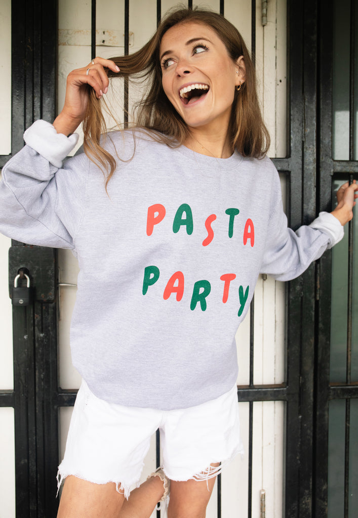 Model wears grey sweatshirt with Pasta Party slogan 