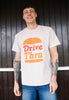 Model wears sand tshirt with Drive Thru slogan and burger graphic 