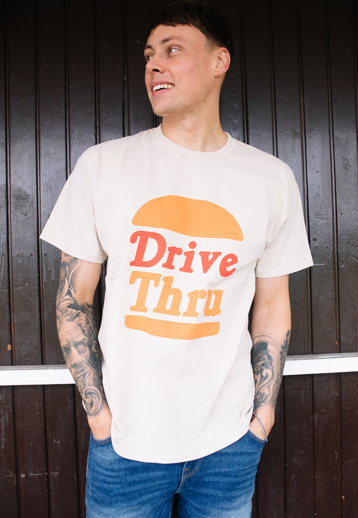 Model wears sand tshirt with Drive Thru slogan and burger graphic